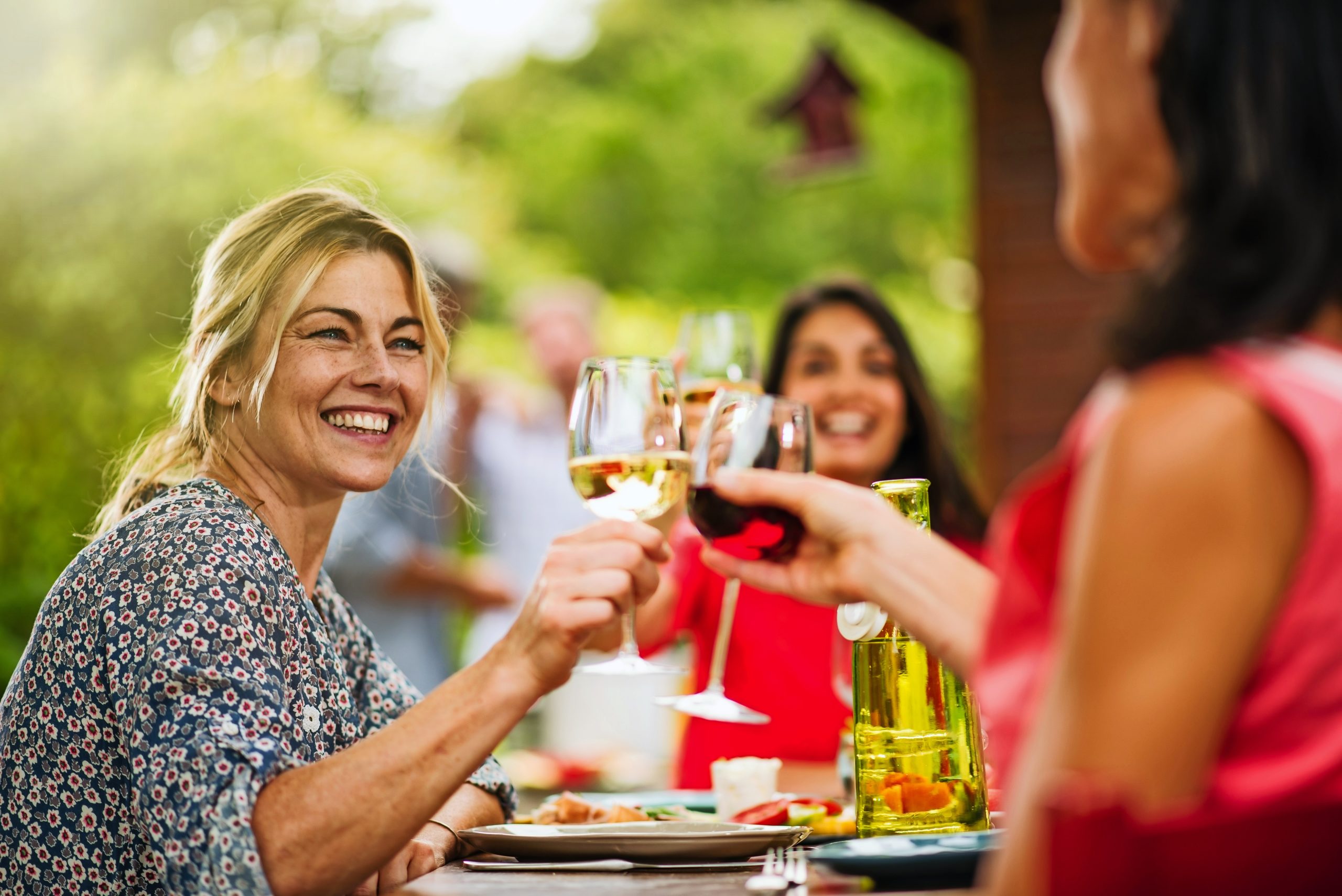 Group of friends having lunch, focus on a woman