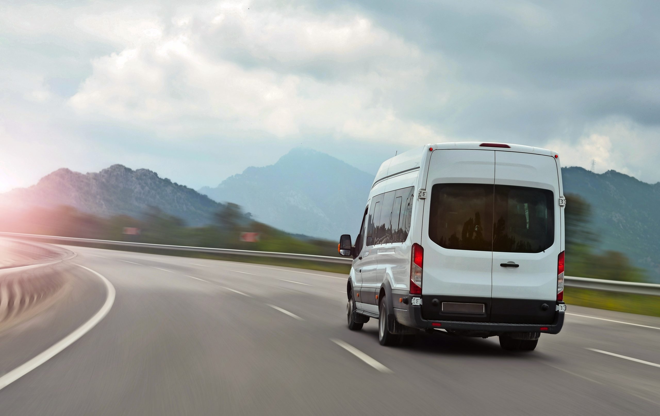 passenger bus van accelerating on a background of mountains